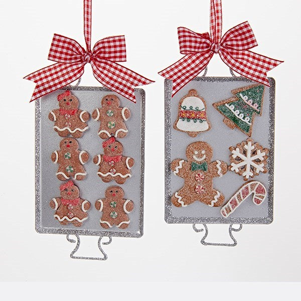 Add a sweet touch to any holiday décor with this assortment of two gingerbread cookie ornaments from Kurt Adler. Each ornament features a metal tray carrying gingerbread cookies, topped with a large red and white gingham bow. One tray is carrying three gingerbread boys and three gingerbread girls, each with frosting details and peppermint buttons and the other try is carrying a gingerbread man, a bell, a tree, a snowflake and a candy cane. Each of the cookies is dusted with glitter to give them a sugar coat