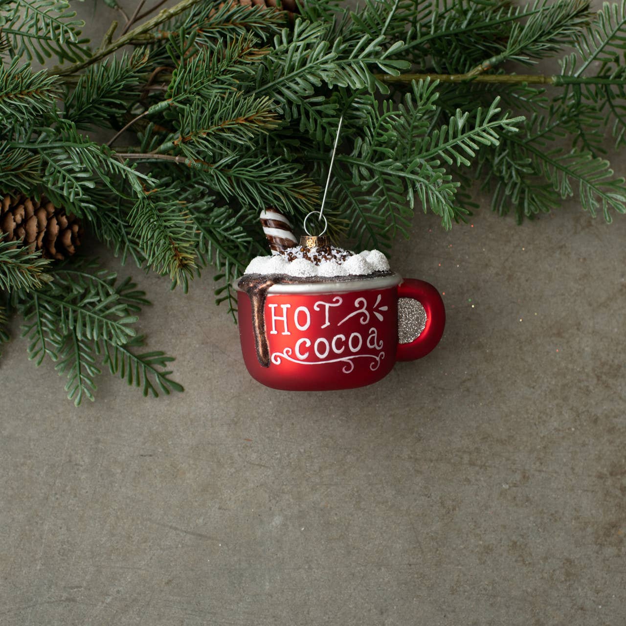 Beautiful metallic red cup ornaments with sentiment hot cocoa. Cup contains hot chocolate, running over side and marshmallows,
Comes in gift box and contains ornament hook
