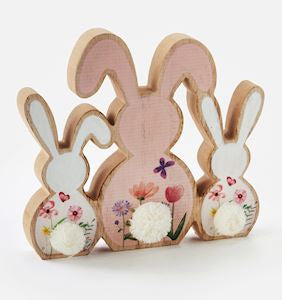 Description: Style your space with charming Easter accents to celebrate the holidays with this adorable Bunnies Wood Decor. Sculpted from wood, this tabletop decor features three sitting white and pink rabbits with colorful floral motifs and white pom pom tails. MDF, Acrylic.