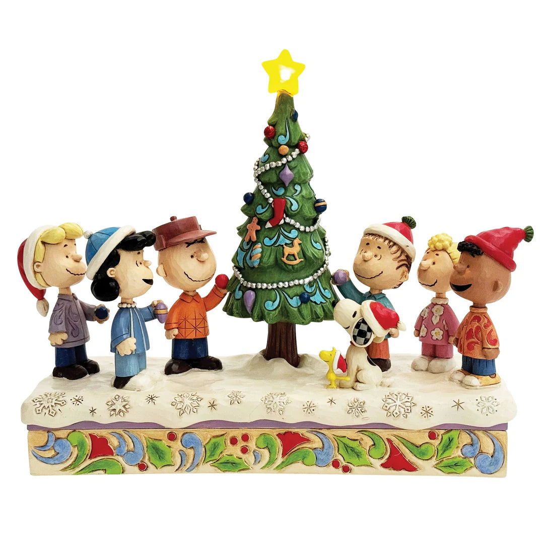 Celebrate the holidays with this heartwarming Jim Shore design of Charlie Brown and his friends decorating a Christmas tree. The charming scene captures the spirit of togetherness, blending Peanuts' beloved characters with Jim Shore's iconic style.