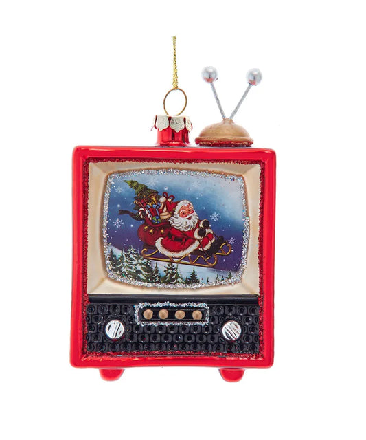Celebrate the holidays with a delightful twist using Kurt Adler's charming Glass Santa TV Ornament! This whimsical ornament features a Santa Claus scene on a vintage television set, bringing a nostalgic touch to your holiday decor. With its vibrant colors and intricate details, this ornament captures the essence of festive cheer, making it a perfect addition to your Christmas tree. Crafted from high-quality glass, it reflects light beautifully, creating a warm and inviting ambiance in your home. Its unique 