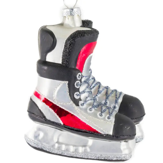 Expertly crafted from glass, this Hanging Silver/Red Glass Hockey Skates Ornament is a must-have for any hockey enthusiast. The stunning red and black skates add a pop of color to your holiday decor, while showcasing your love for the sport. A perfect addition to your tree or gift for any hockey fan.