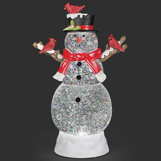 Add a touch of nature’s winter magic to your holiday decor with this charming lighted swirl snowman, beautifully accented by bright red cardinals. Swirling glitter and a soft, gentle glow create a tranquil, festive scene that brings peace, warmth, and seasonal charm to any space during the holidays.

Material: Acrylic

Power: USB cord included or 3 AA batteries required (not Included)

Size: 12" H