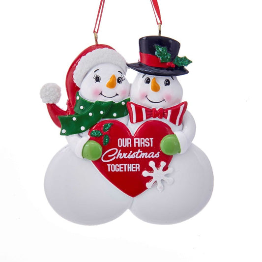 Celebrate your first Christmas together with our 3.75" OUR FIRST XMAS TOGETHER ORNAMENT. Featuring two adorable snowmen holding a red heart that symbolizes your love and special milestone. Perfect for creating lasting memories and cherishing your first holiday season as a couple.