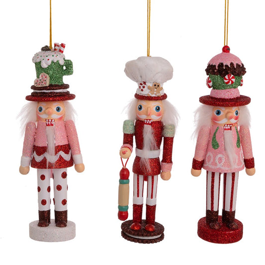 Add a touch of charm to your Christmas decor with our beautiful 6 inch Cake/Cocoa/Gingerbread Nutcracker Ornaments. These nutcrackers feature unique hat styles in festive red, green, and pink colors. Hang them on your Christmas tree, garland, or tiered tray for a fun and whimsical touch.